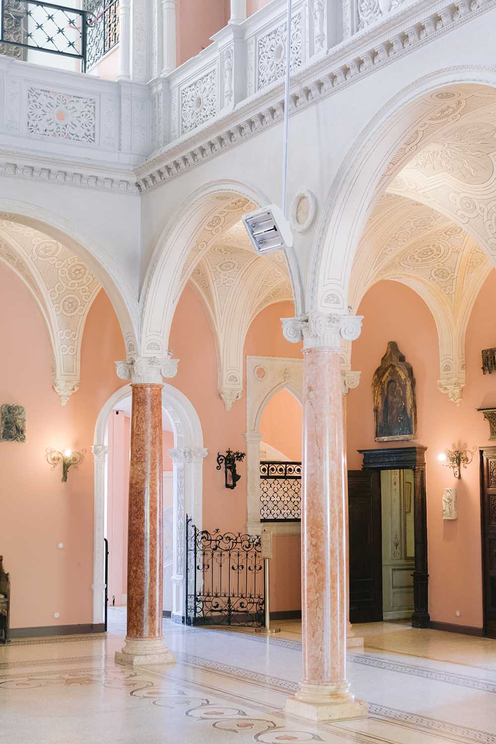 Pink marble columns and decorated arcades in the central patio of Villa Ephrussi de Rothschild